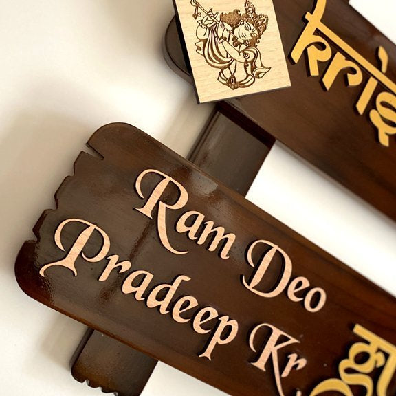 Close-up of raised 3mm letters on brown teak wood name plate with glossy polish