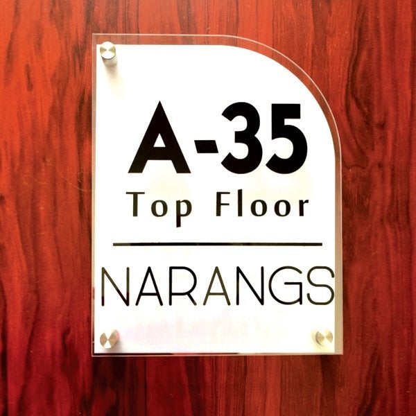 Close-up of black acrylic letters on the two layered clear and white acrylic name plate